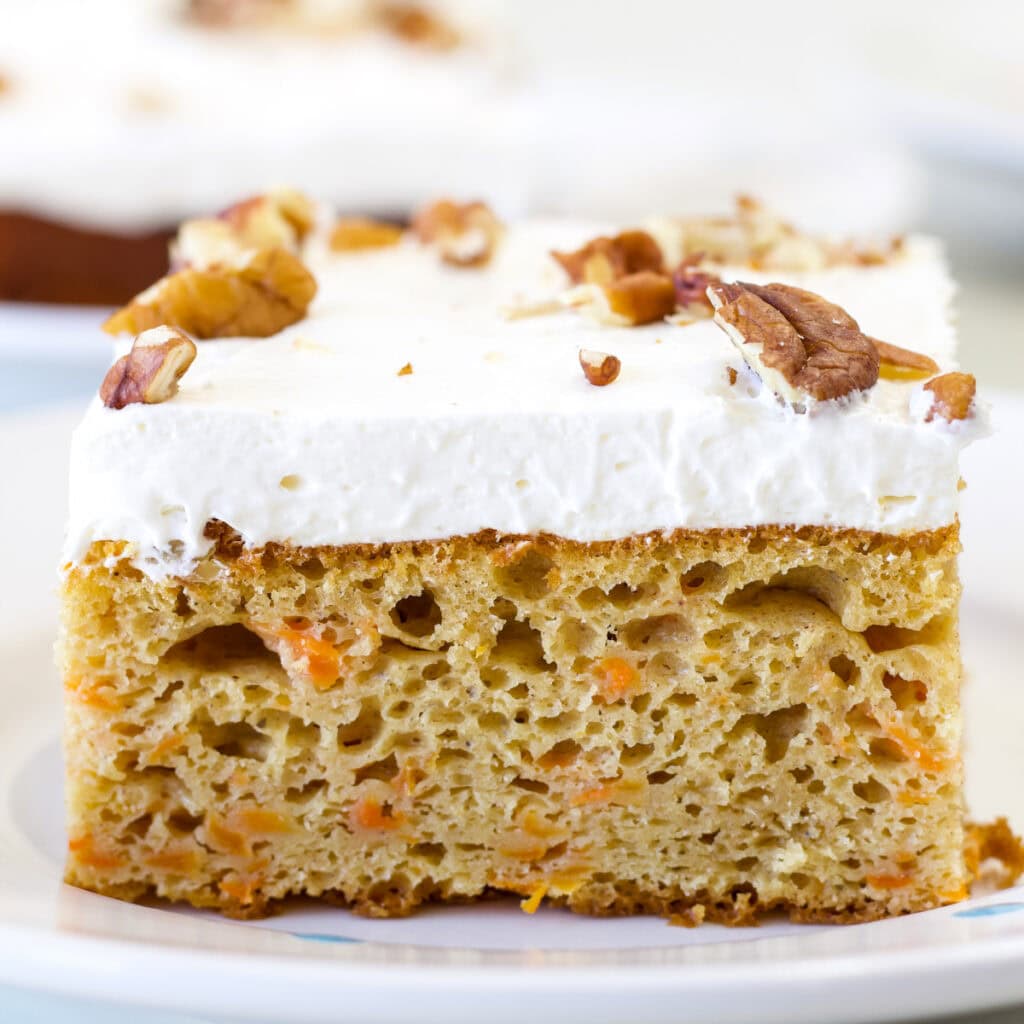 Feature image on a close up of the side of one piece of Carrot Cake Using Yellow Cake Mix.