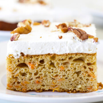 Feature image on a close up of the side of one piece of Carrot Cake Using Yellow Cake Mix.