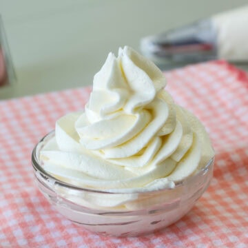 Feature image of some cream cheese frosting in a small glass bowl.