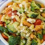 Feature image of an overhead shot of the serving bowl filled with rainbow pasta salad.