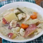 Feature image of a close up of one serving of Slow Cooker Chicken Stew in a white bowl.
