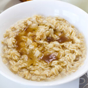 Feature image of an overhead shot of the bowl of Copycat Quaker Maple Brown Sugar Oatmeal.