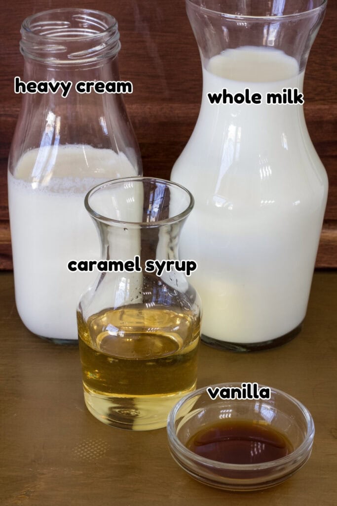 Bottles of heavy cream, milk and caramel syrup and a small bowl with vanilla extract that is needed to make the Homemade Caramel Coffee Creamer recipe.