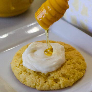 Feature image of the one frosted cookie with honey being drizzled on top.