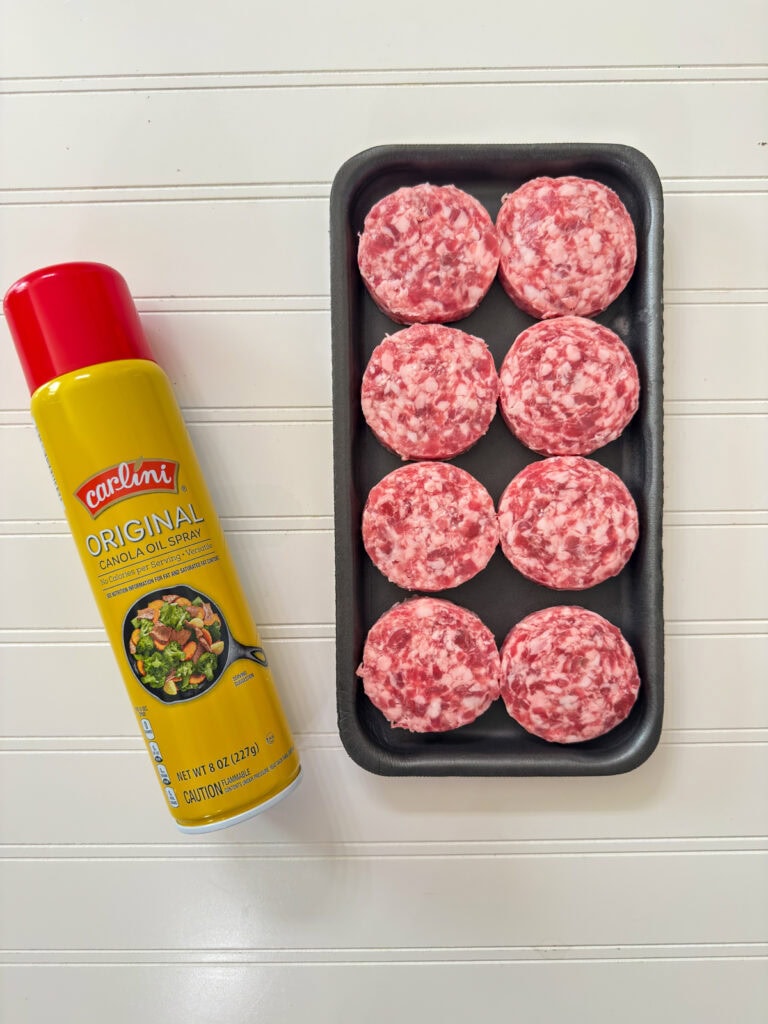 A package of raw sausage patties and a can of nonstick cooking spray.
