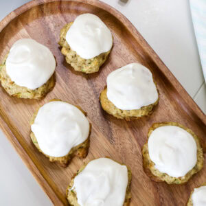 Feature image of several frosted cookies on a small wooden serving tray.