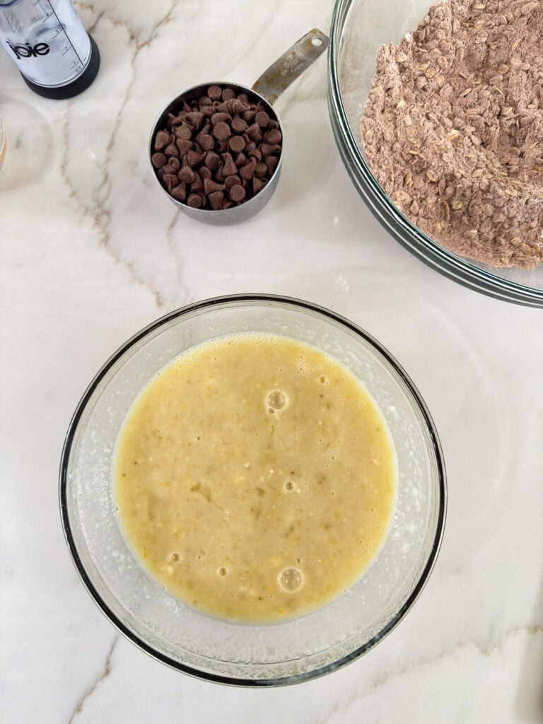 The wet ingredients mixed together in a medium glass mixing bowl.