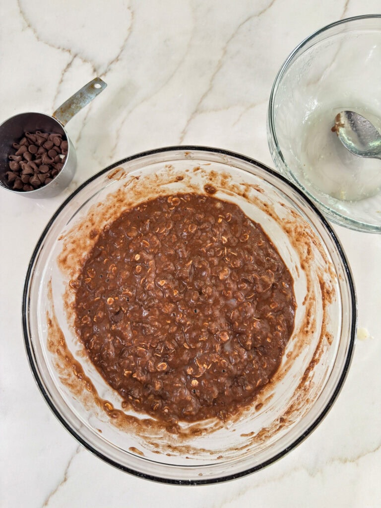 The wet and dry ingredients mixed together in a large glass bowl.
