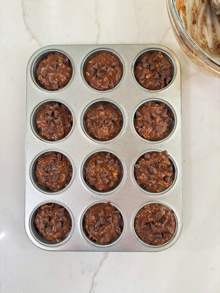 The unbaked muffin batter in the prepared muffin tin ready to go into the oven.