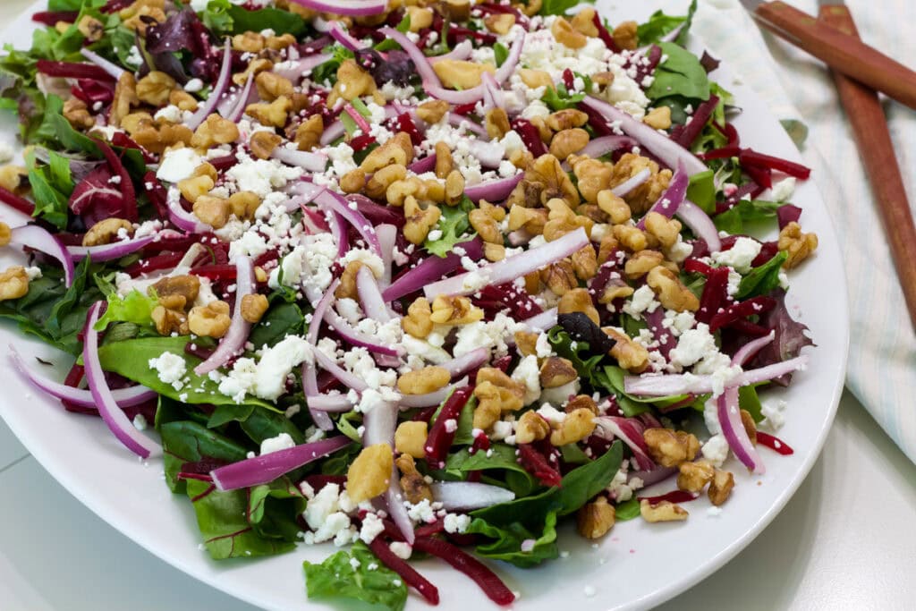 Half of the platter of Green Salad with Beets and Goat Cheese is visible in this shot.