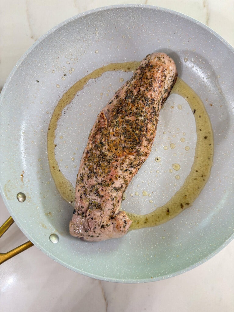 The pork tenderloin after it's been seared on the stove top, ready to go into the oven.