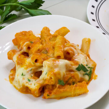 Feature image of one serving of Vodka Sauce Baked Ziti on a white plate.