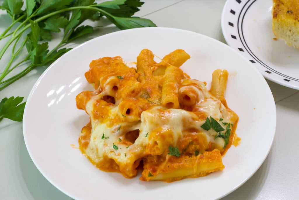 Close up of one serving of Vodka Sauce Baked Ziti on a white plate.