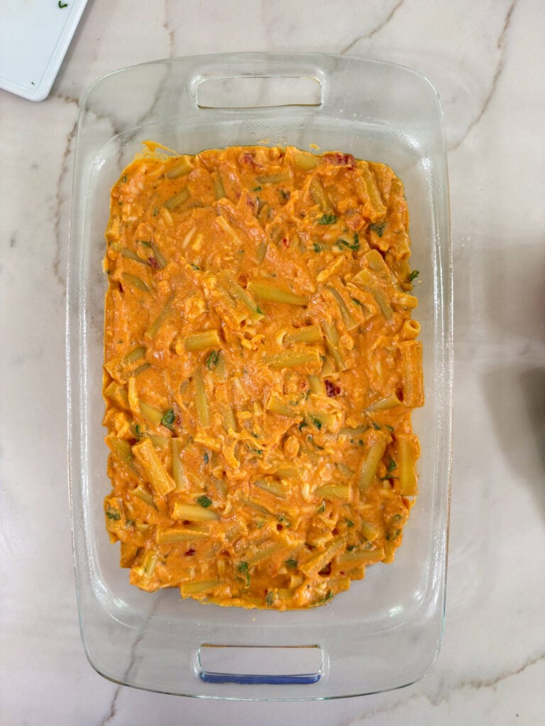 The pasta mixture added to the casserole dish