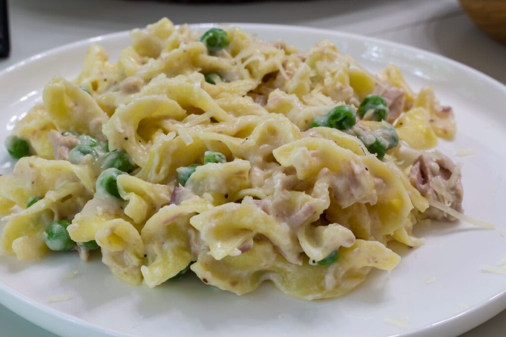 One serving of Pasta with Tuna and Peas on a white plate.