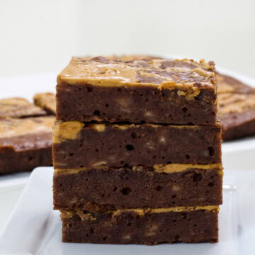 Feature image of four brownies stacked on top of each other so the inside is visible.