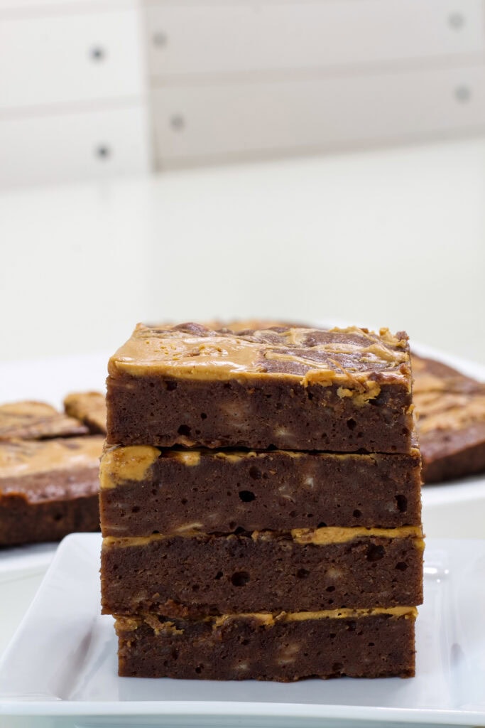Four cut Peanut Butter Chocolate Banana Brownies stacked on top of each other so the texture is visible.