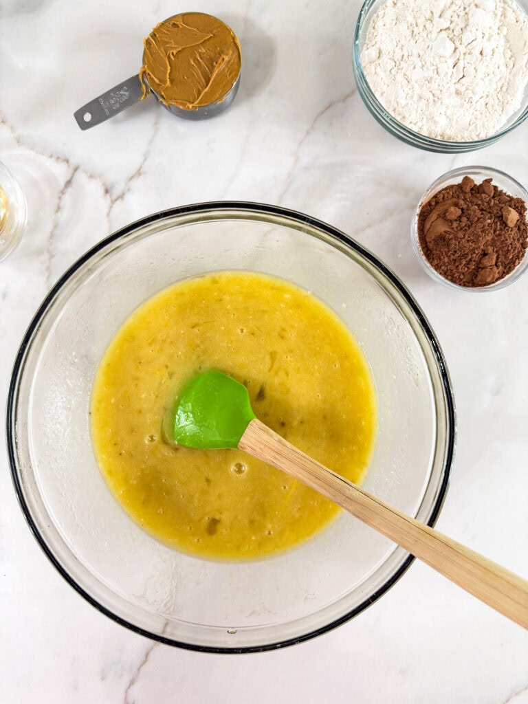 The wet ingredients mixed together in a glass mixing bowl.