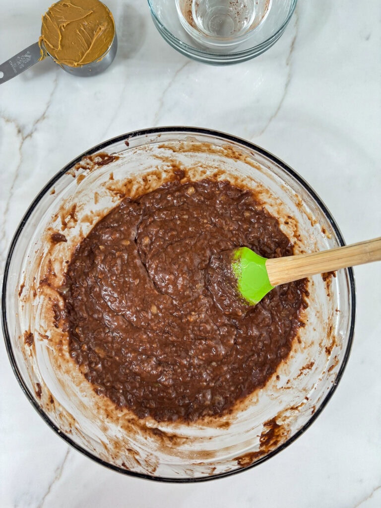 The dry ingredients added to the glass bowl after being mixed together.