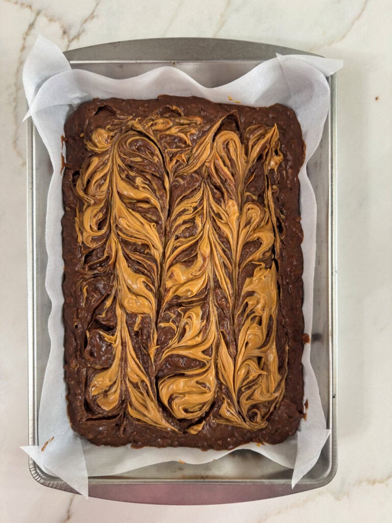 The brownie batter after the peanut butter has been swirled around.
