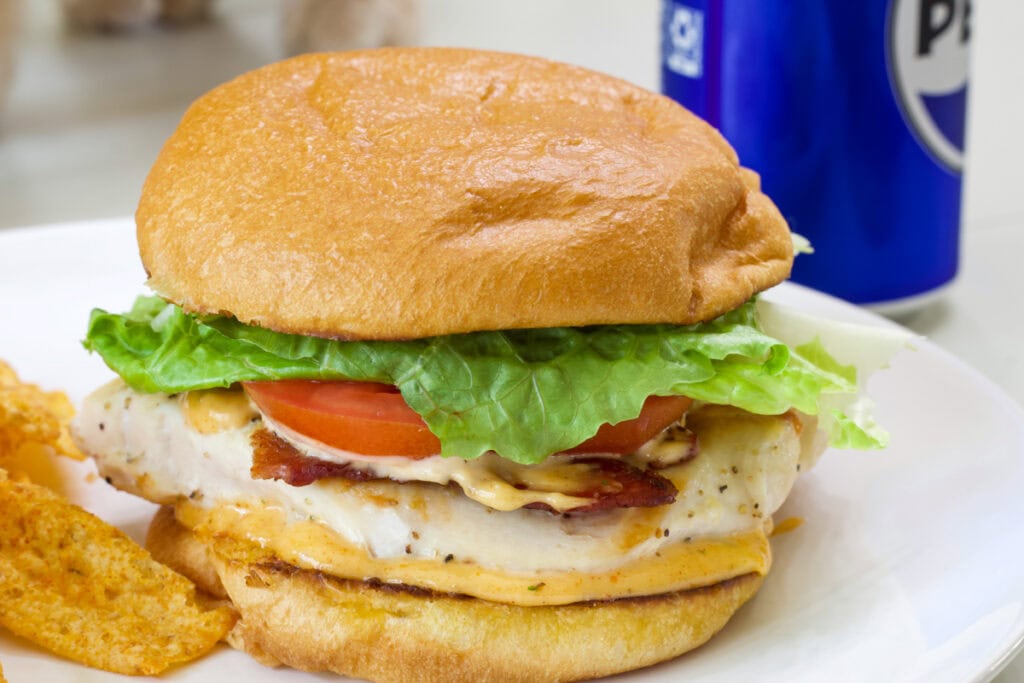 Side view of the sandwich with a Pepsi in the background.