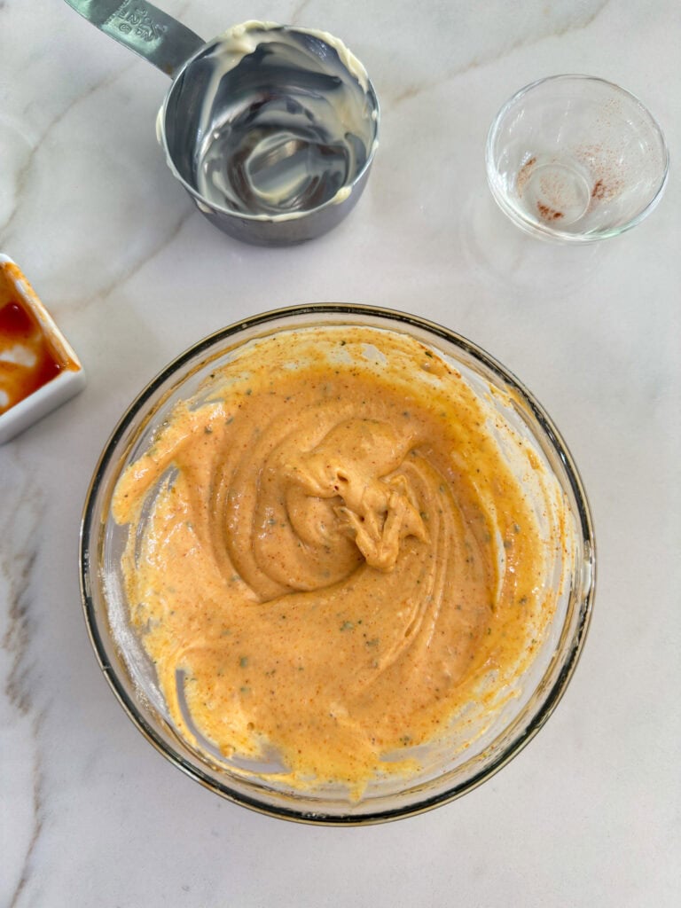 The completed spicy ranch mayo mixed in a small glass bowl.