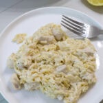 Feature image of one serving of Creamy Lemon Chicken Orzo on a white plate.