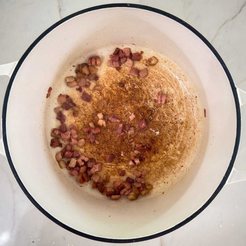 The pancetta after it's been browned and the fat rendered in a large pot.