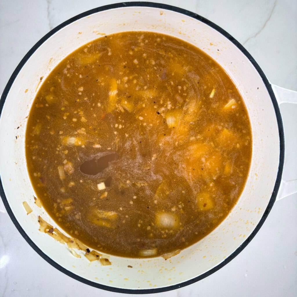 The broth and potatoes added to the meat, onion and garlic.