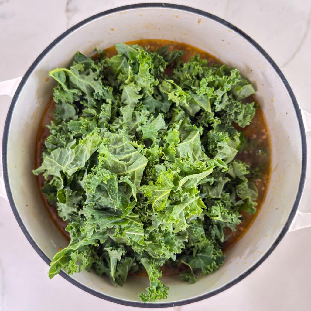 The kale added to the pot before the beans have been added.