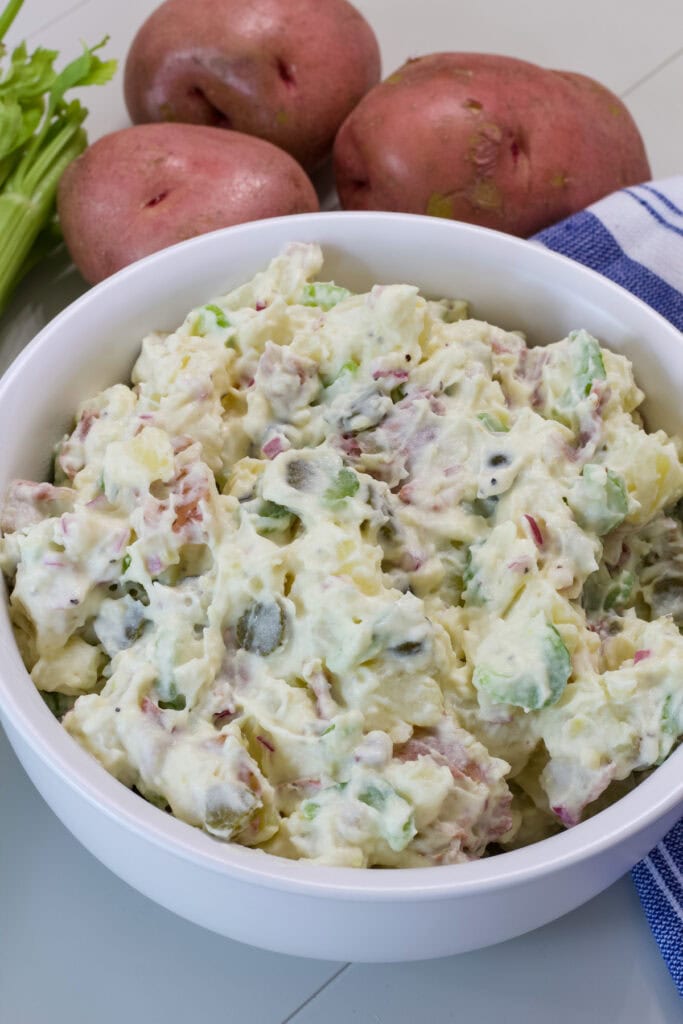 A serving bowl filled with the finished Healthy Potato Salad (no eggs).