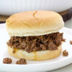 Side view of the Loose Meat Sandwich on a white plate.
