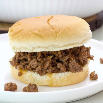 Side view of the Loose Meat Sandwich on a white plate.