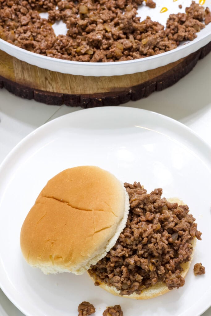 The loose meat on a bun with the top bun off to the side.