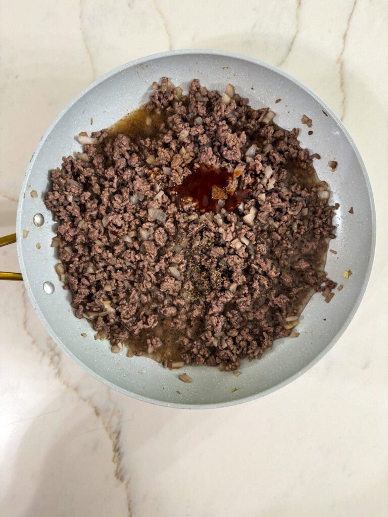 The beef with the steak sauce, soy sauce, water, and bouillon cube added.