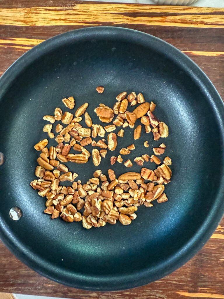 The chopped pecans in a dry nonstick skillet after they've been toasted.
