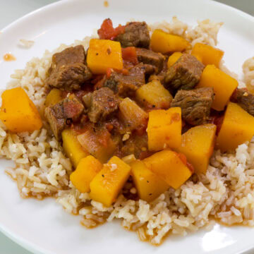 Feature image of a close up of a serving of tagine on a white plate.