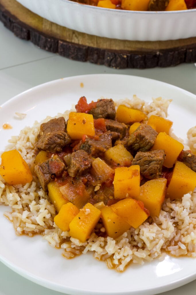 One serving of Beef Tagine with Butternut Squash on a bed of brown rice.