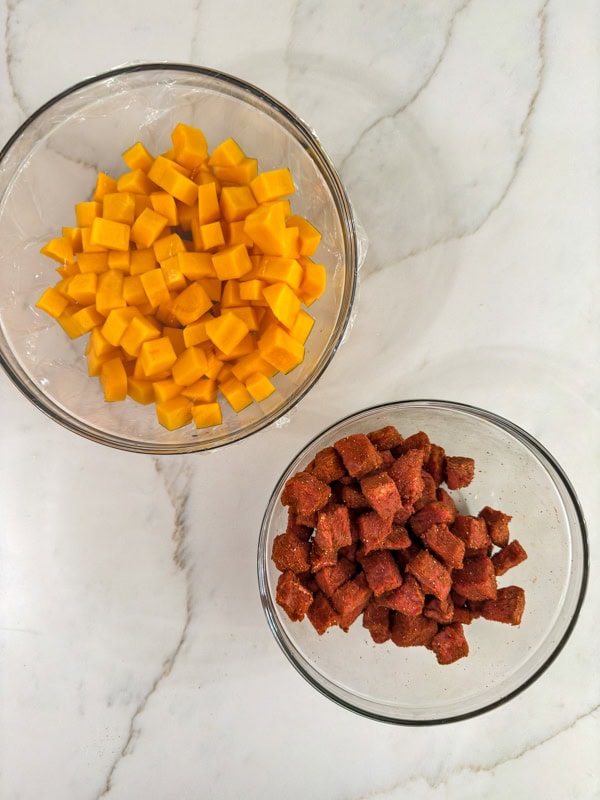 The cubed beef with spices and butternut squash in bowls.