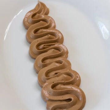 Feature image of some frosting piped on a white plate.