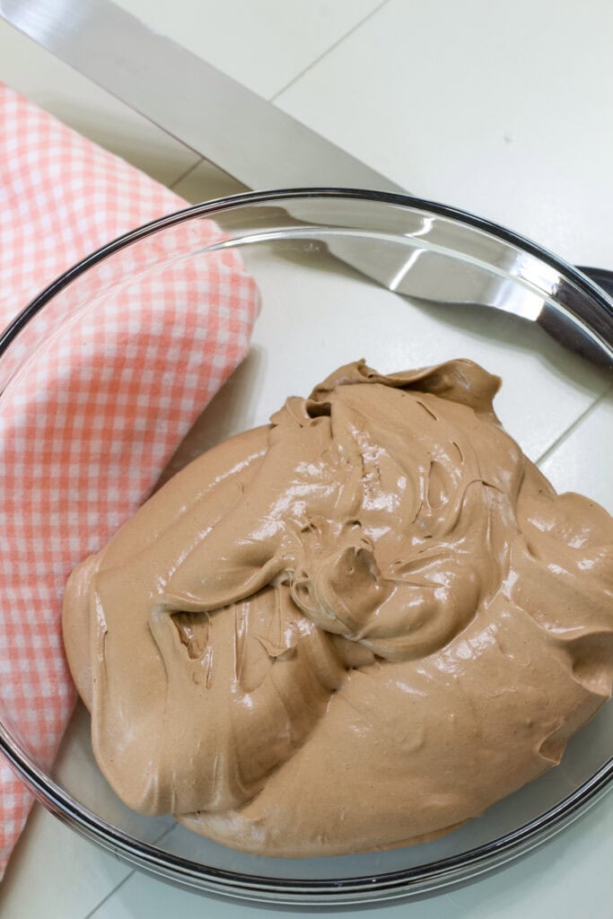 The entire batch of Chocolate Pudding Cool Whip Frosting in a clear glass mixing bowl.