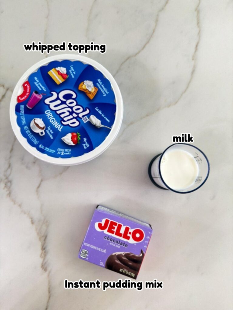 A tub of Cool Whip, box of chocolate pudding, and half cup of milk needed to make the Chocolate Pudding Cool Whip Frosting recipe.