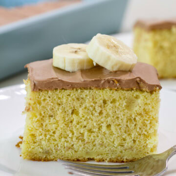 Feature image of a close up view of one piece of Easy Cake Mix Banana Cake.