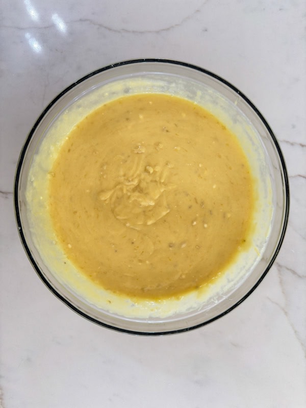 The mixed cake batter in a large mixing bowl.