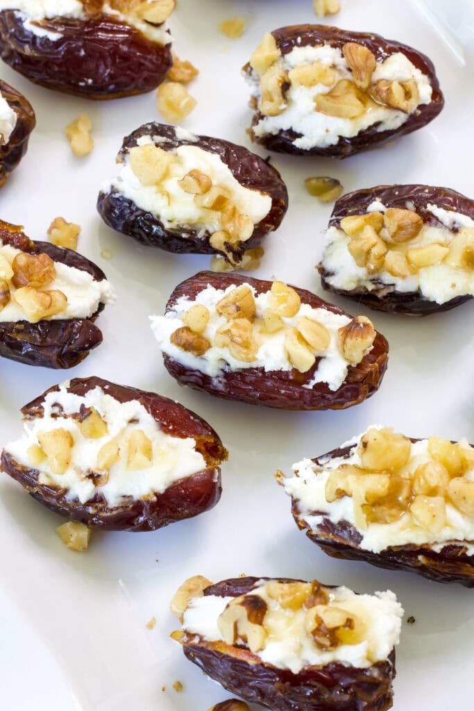 Overhead shot of many Goat Cheese Stuffed Dates on a serving platter ready to eat.