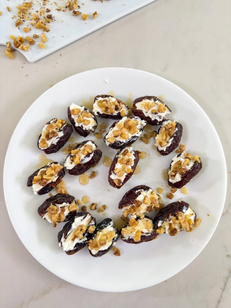 The stuffed dates after they've been topped with chopped nuts and a drizzle of honey.
