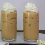 Side view of two Iced White Chocolate Mochas on a white plate.