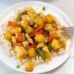 Feature image of one serving of Orange Pineapple Chicken on a bed of rice.