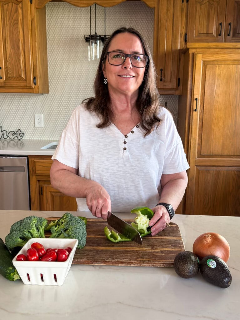 Me in my kitchen cutting vegetables.