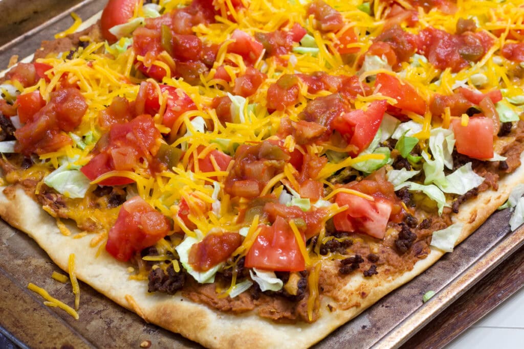 Side view of the entire baked and topped Super Easy Taco Pizza.
